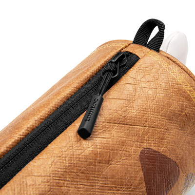 Túi Đeo Chéo TOMTOC MHRS-T14 Monster Hunter Steak Brown Gọn Nhẹ Linh Hoạt Thiết Kế Hình Trụ Cho Nhiều Không Gian Chứa Hàng Chính Hãng